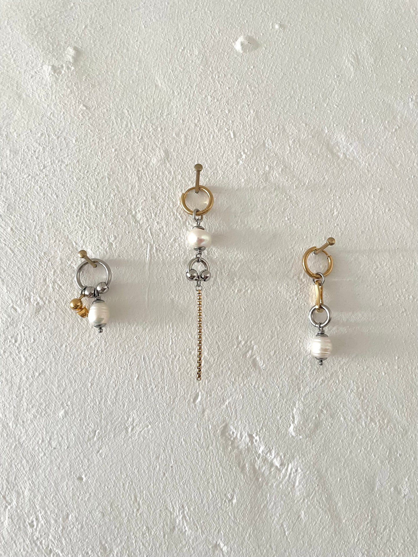 Mixmatched Santa Perla earrings by Eloy Sant