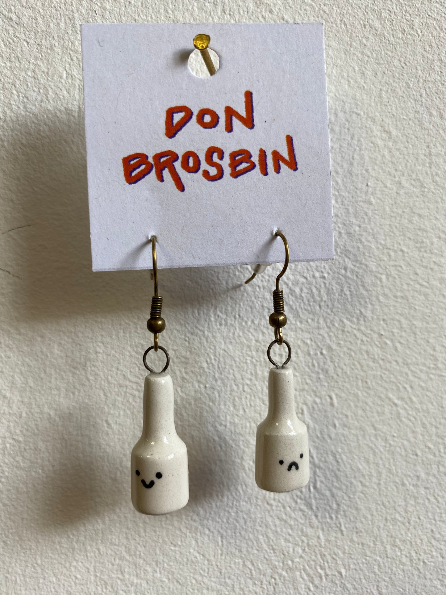 Happy Sad Bottle handmade ceramic earrings by Don Brosbin