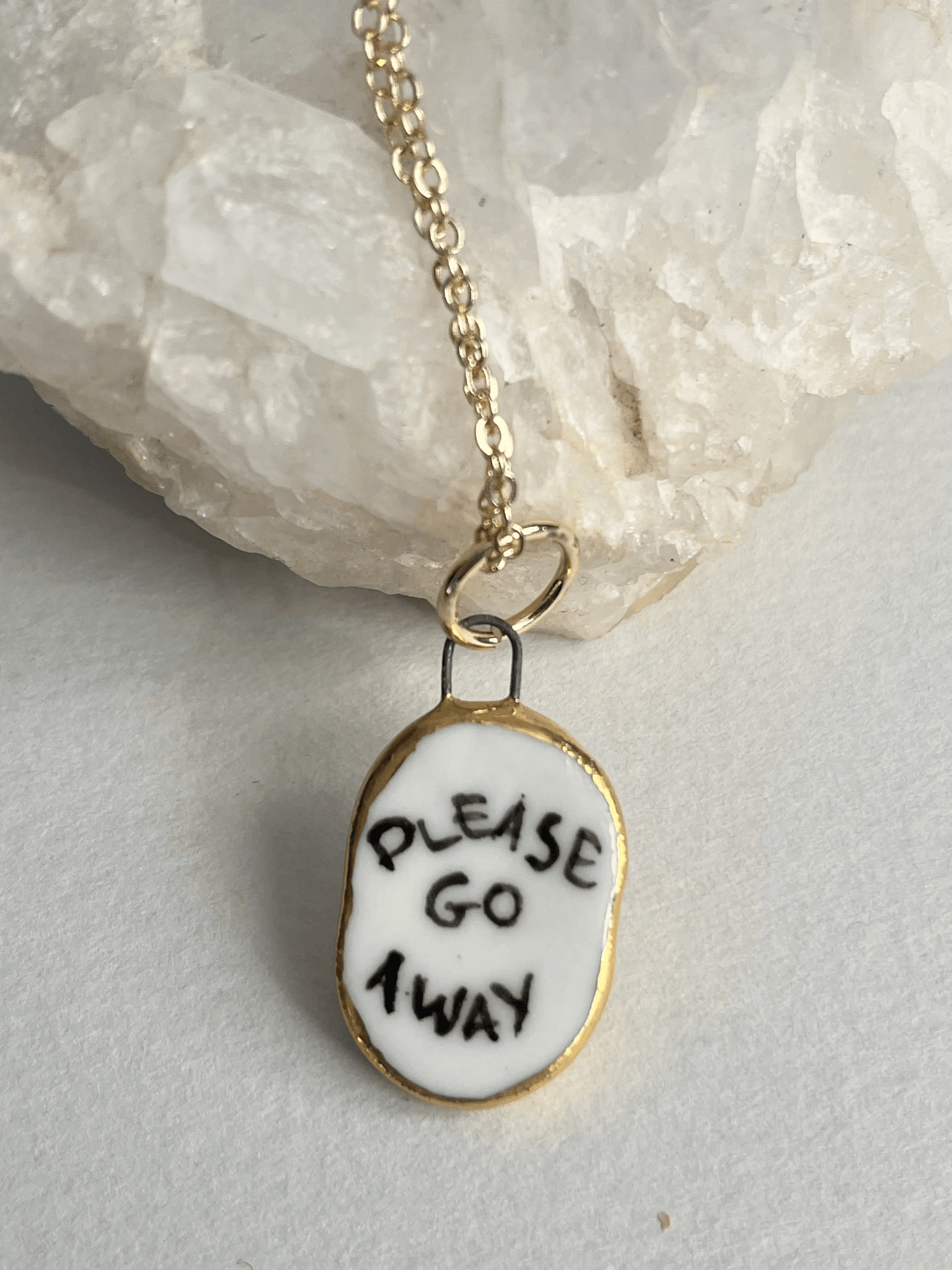 Porcelain oval "Please go Away" pendants with gold rim by REBECCA EDELMANN Ceramics