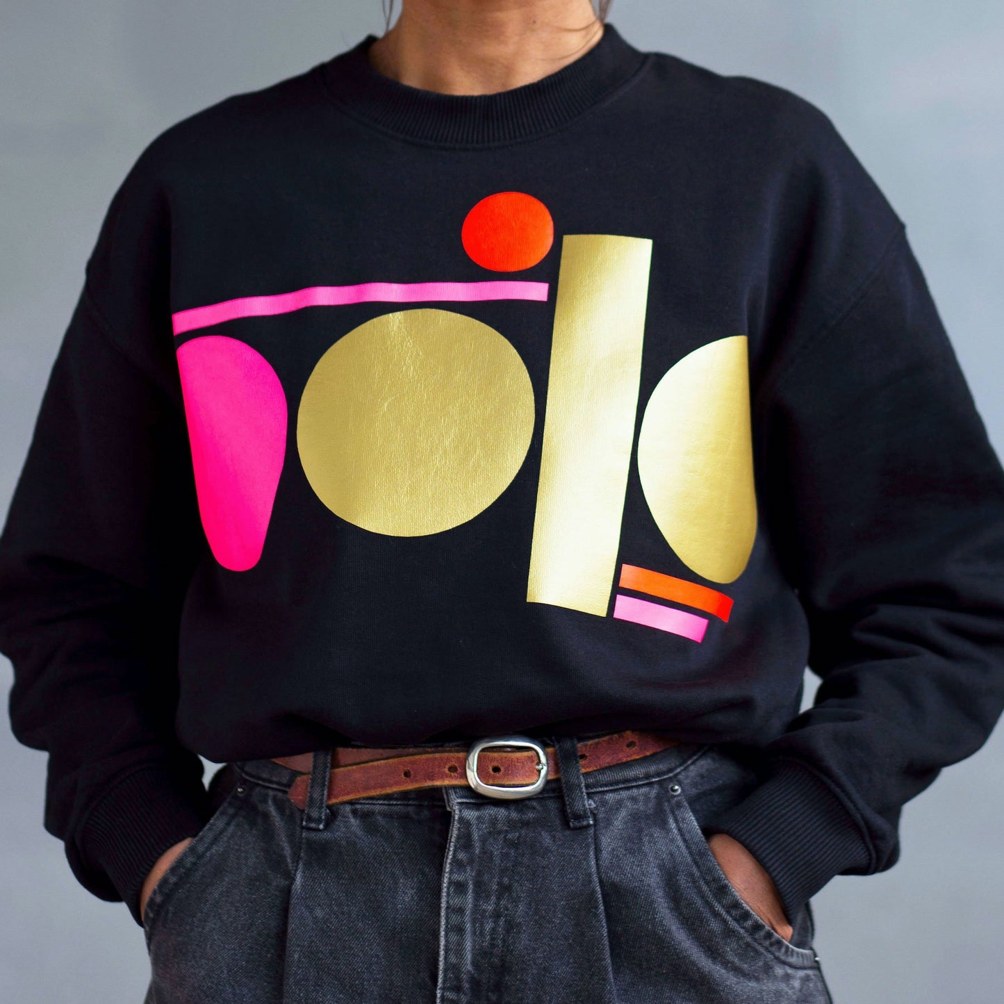 neon pink and gold tag on black sweatshirt - women’s fit by Touch Press Studio