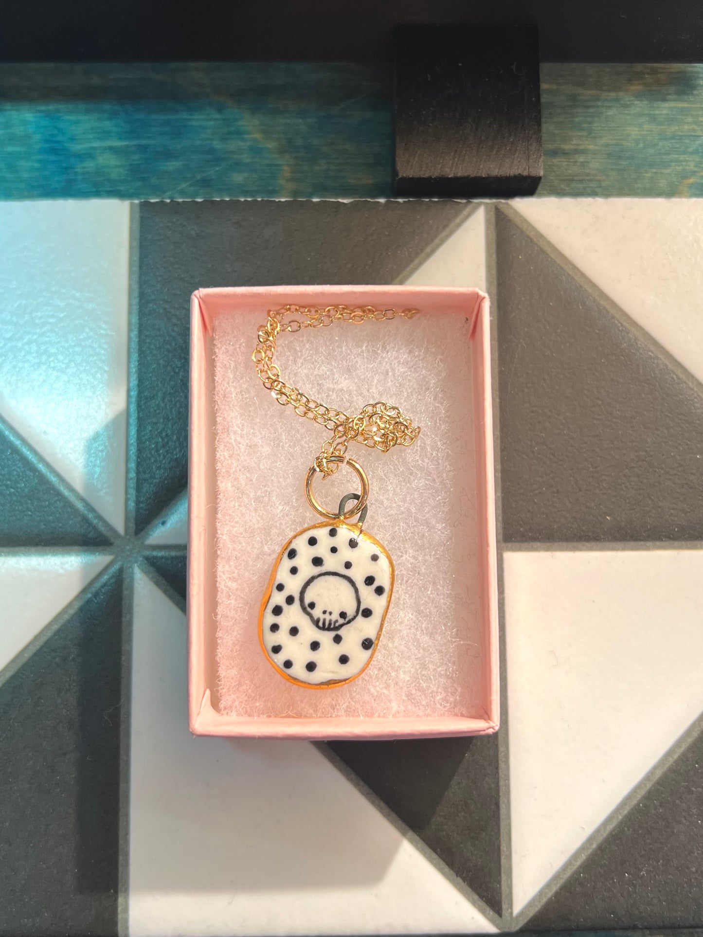 Porcelain Skull Pendant with gold rim by REBECCA EDELMANN