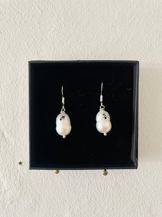 Mixmatched Santa Omiche earrings  by Eloy Sant