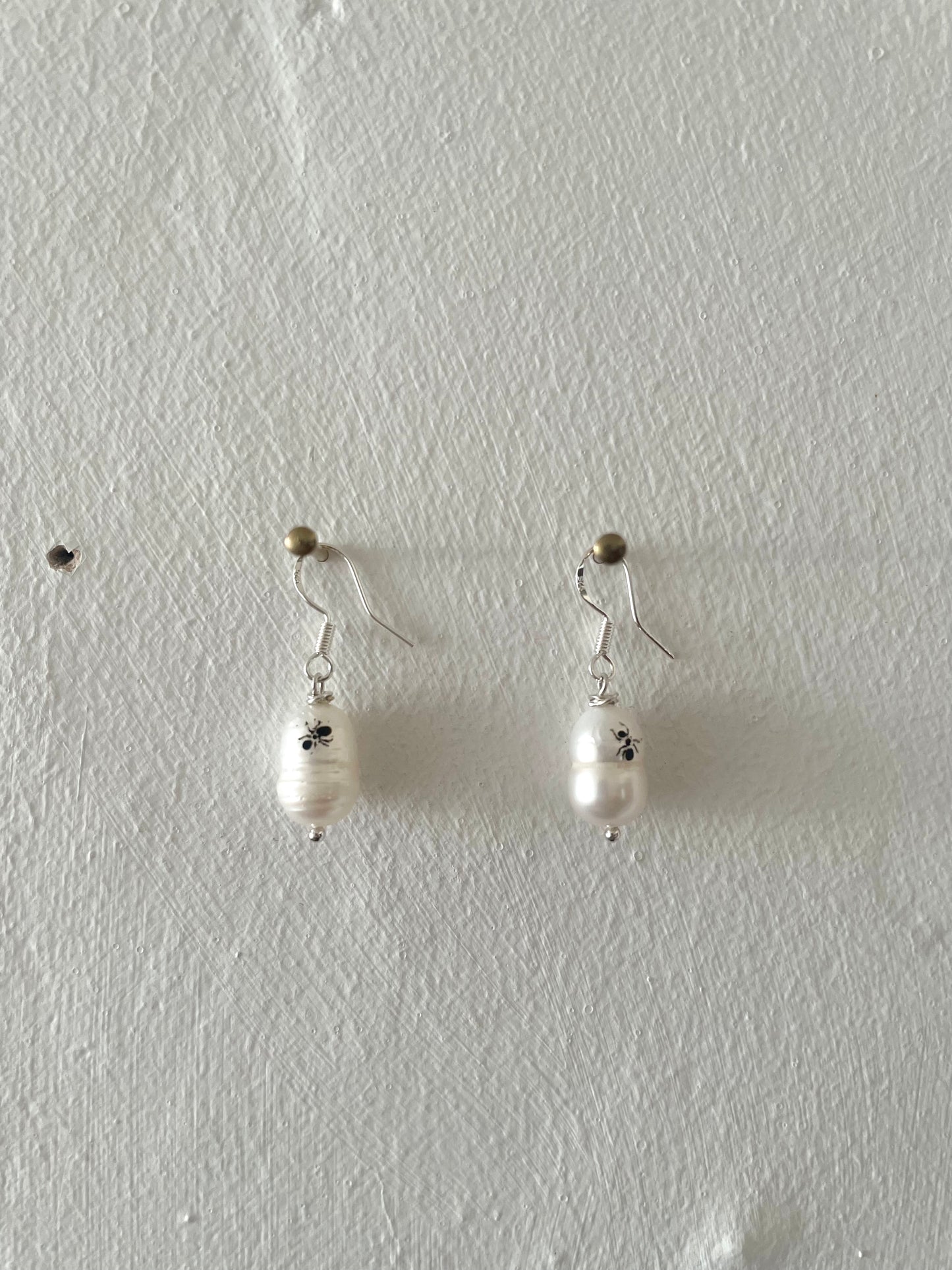 Mixmatched Santa Omiche earrings  by Eloy Sant