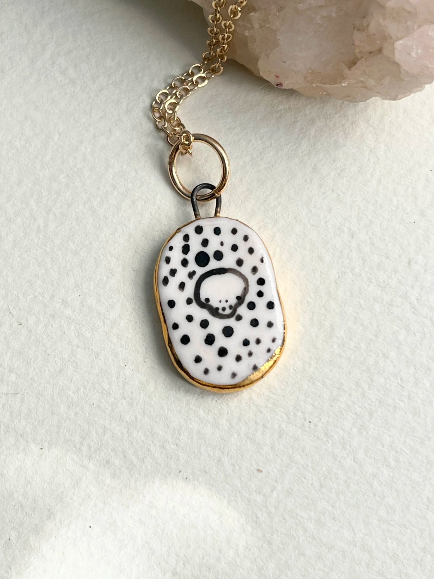 Porcelain Skull Pendant with gold rim by REBECCA EDELMANN