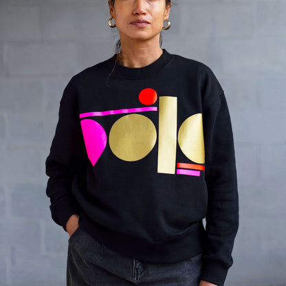 neon pink and gold tag on black sweatshirt - women’s fit by Touch Press Studio