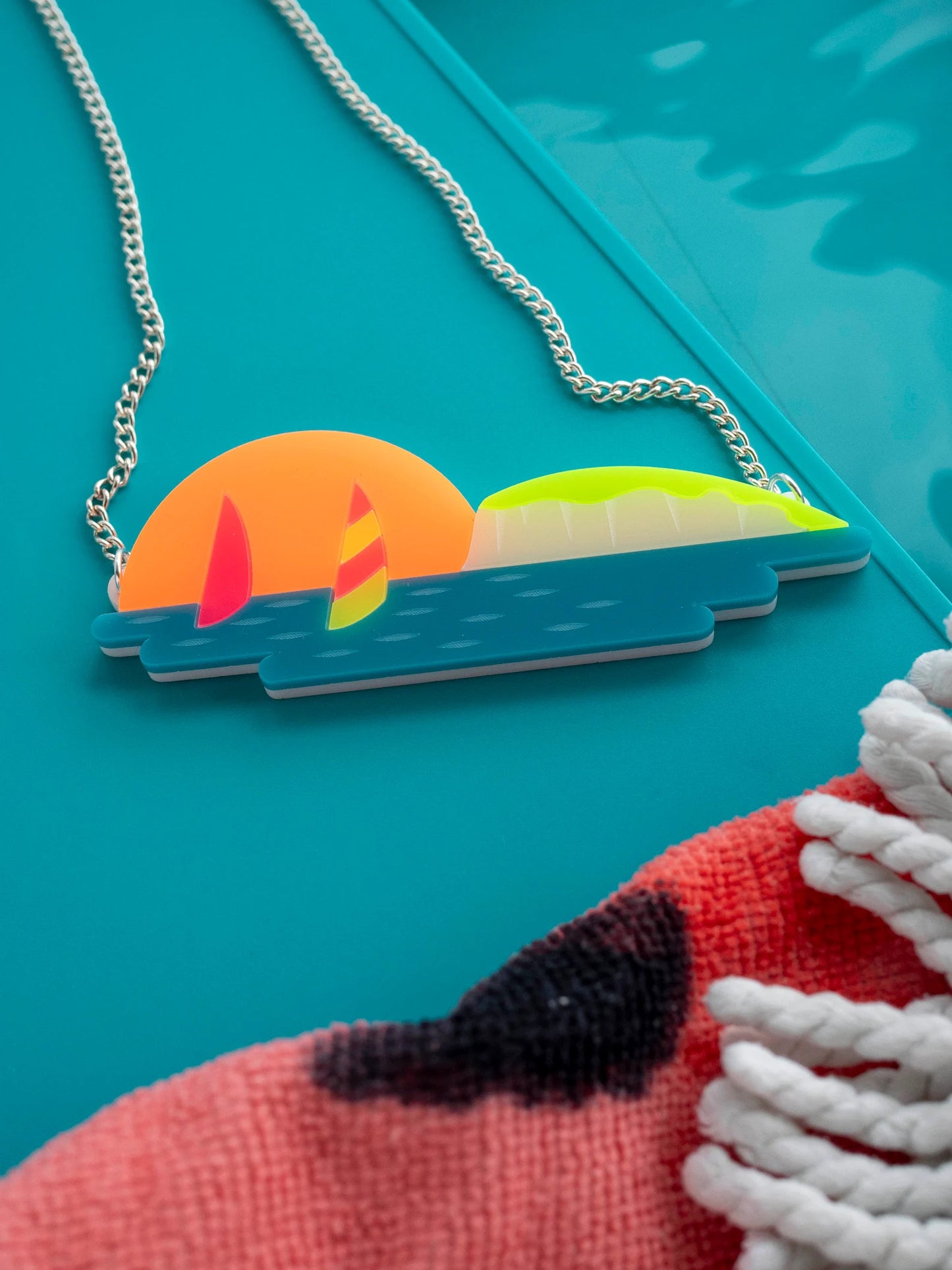 Windsurfing sunset scene necklace by Designosaur