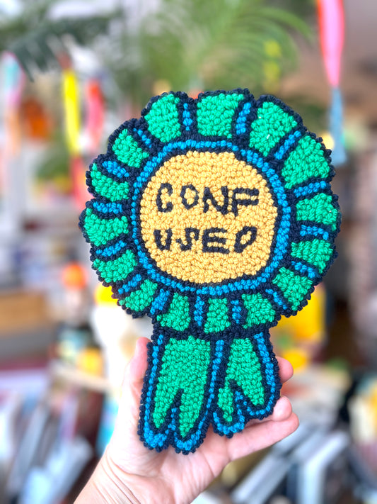 Needle Punched Wall Hanging 'Confused' Badge By Don Brosbin