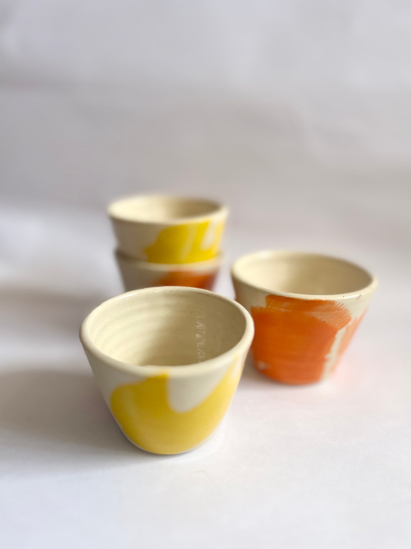 Yellow And Orange Ceramic Cups By Windmill